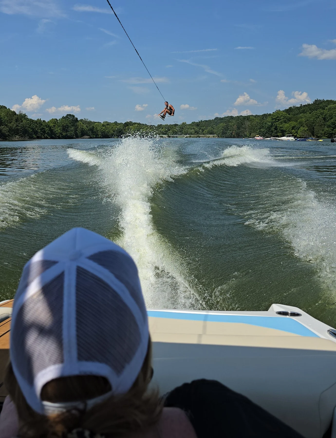 Wakeboard rider holding a grab above the wake during Board Bonanza