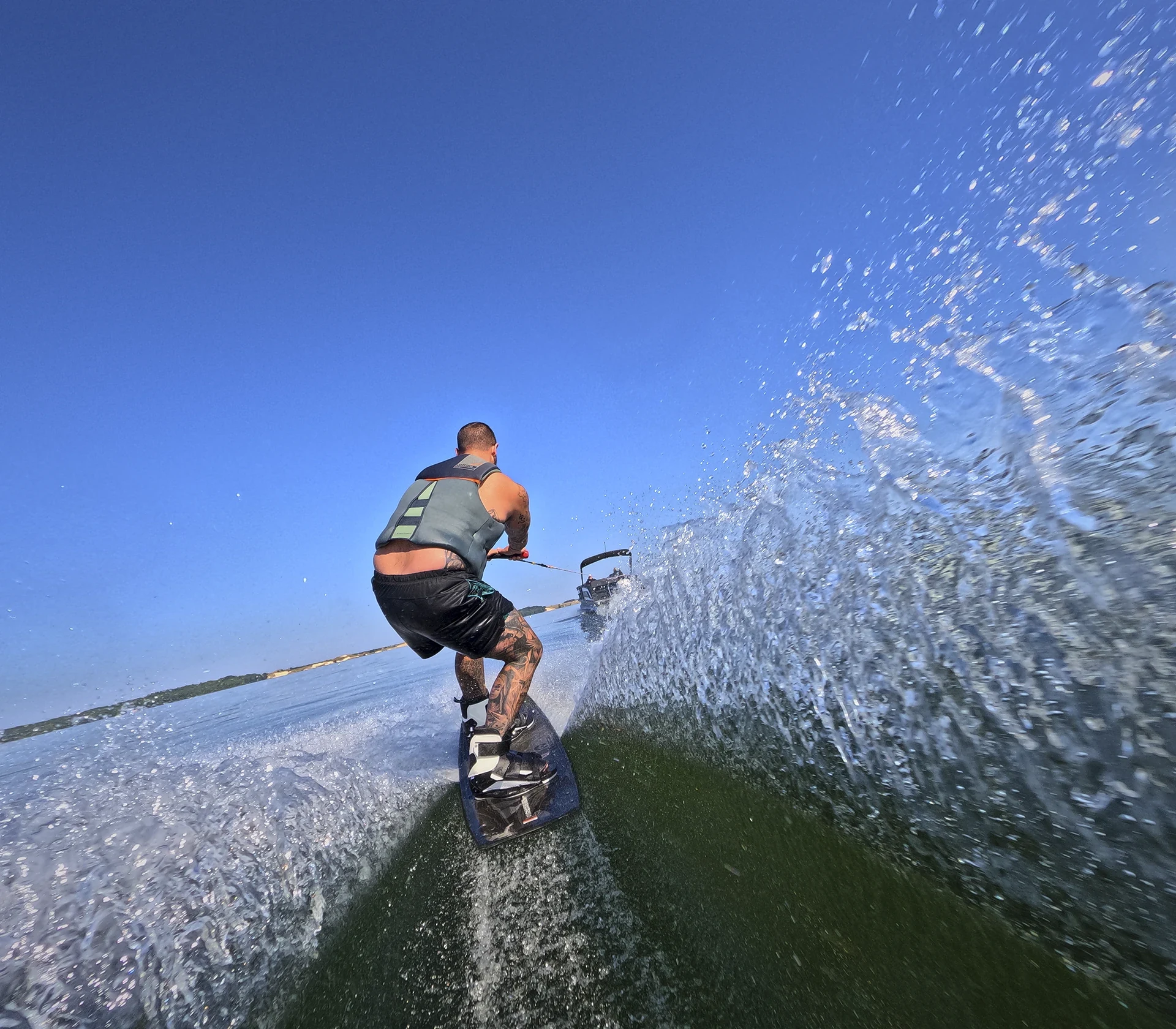 Wakeboarder riding behind an Evotti 700 Series 23CS