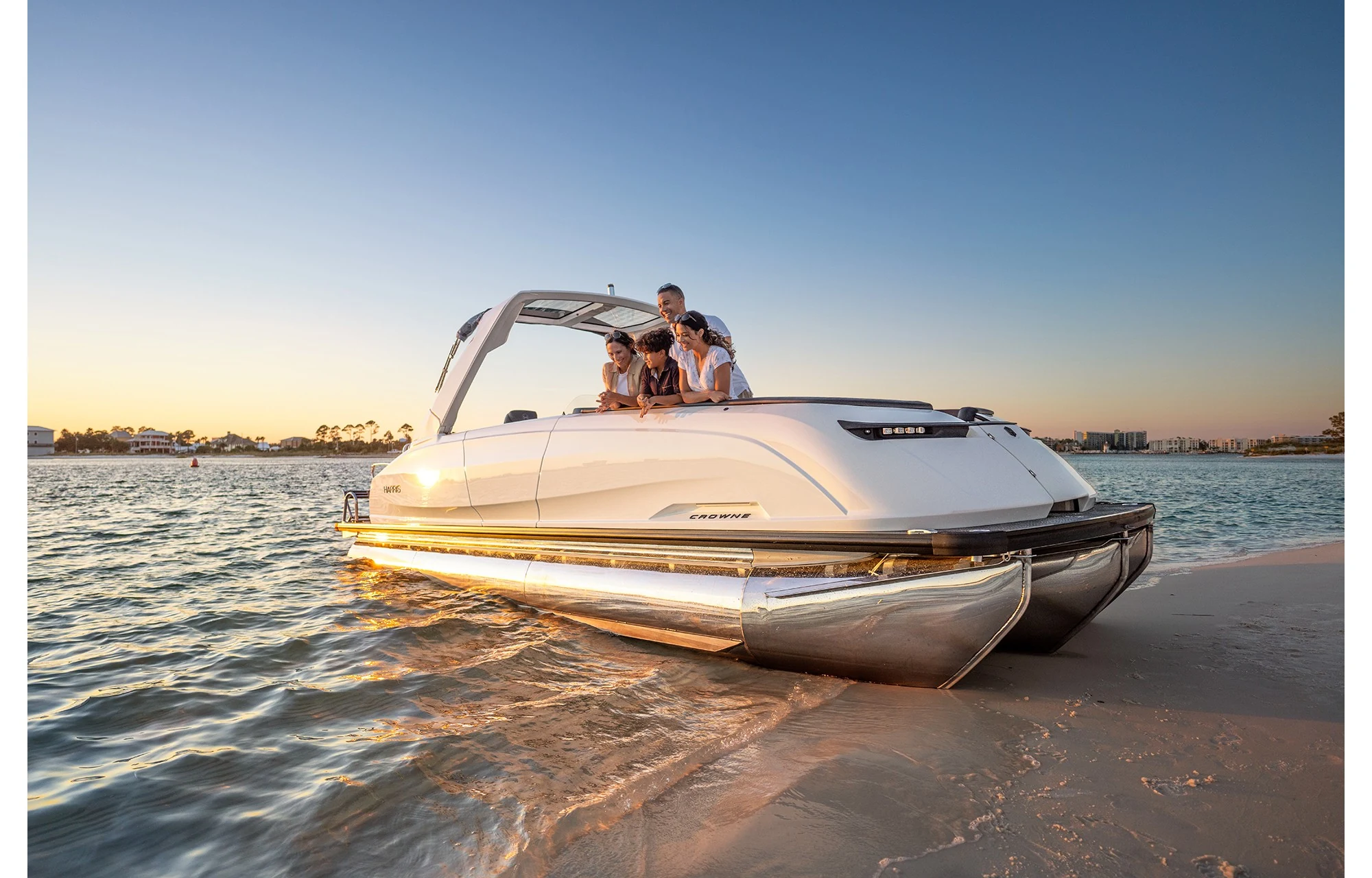 Harris Crowne 250 beached at sunset with a couple aboard