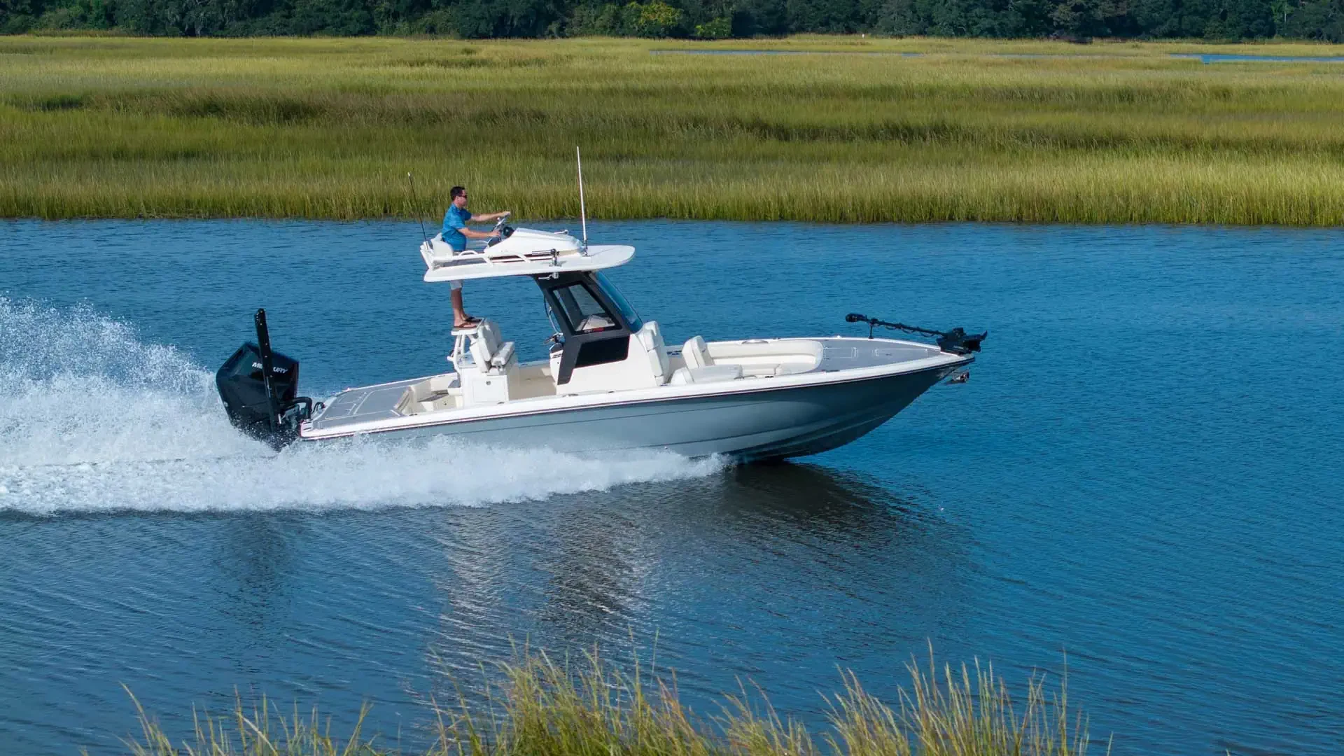 Scout 281 XSS running along marsh-lined water
