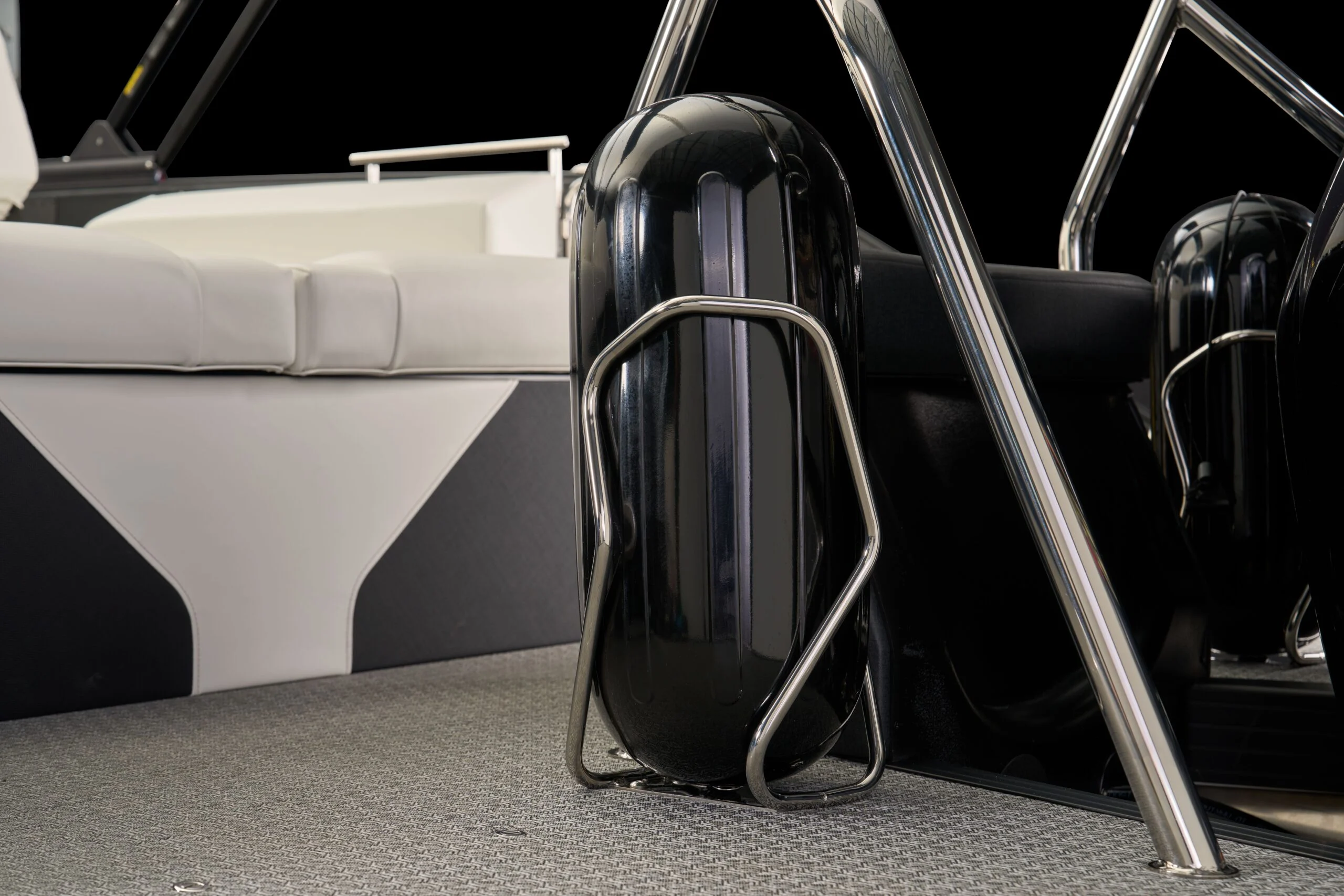 Gloss-black fender and stainless rails aboard an Evotti pontoon
